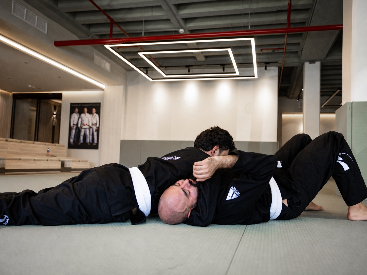 Three adult students training Brazilian Jiu-Jitsu at Alliance Kuwait
