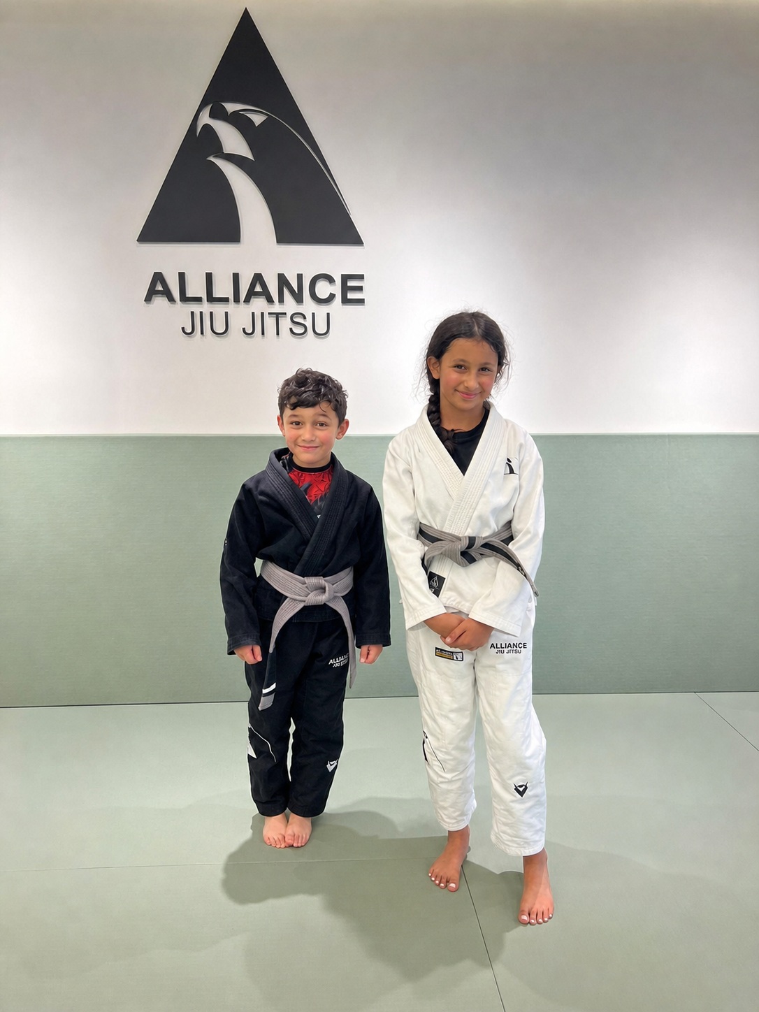 Two children in Brazilian Jiu-Jitsu uniforms at Alliance Kuwait
