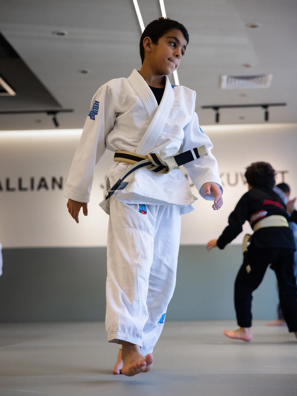 A young student in a white gi during a Youth class at Alliance Kuwait
